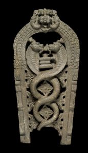A southern-Indian carved-stone stele depicting Shiva as a lingam - a makara head is at the top of the arch - the central area has two intertwining cobras